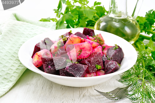 Image of Salad of beets and potatoes in plate on table