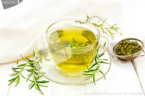 Image of Tea of rosemary in cup with napkin on light board