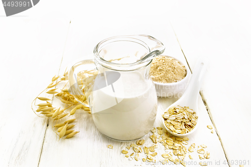 Image of Milk oatmeal in jug on light wooden board