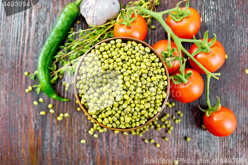 Image of Mung beans  in bowl with vegetables and thyme on board top