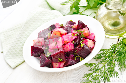 Image of Salad of beets and potatoes in plate on light table