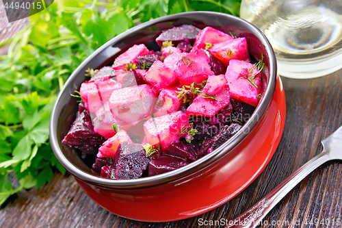 Image of Salad of beets and potatoes in bowl on board