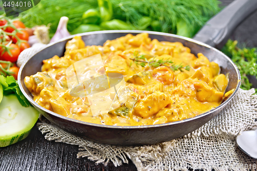 Image of Goulash with tomato and zucchini in pan on table