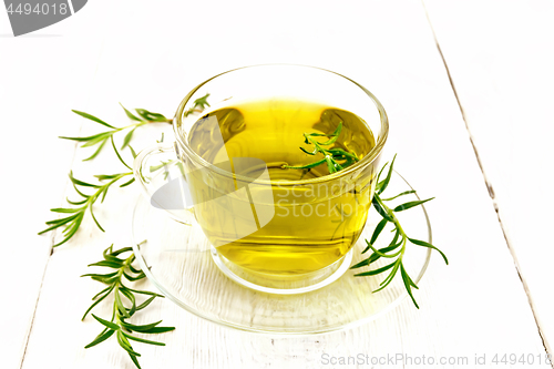 Image of Tea of rosemary in cup on light board
