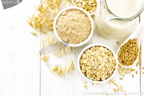 Image of Oat flakes with flour and milk on light board top