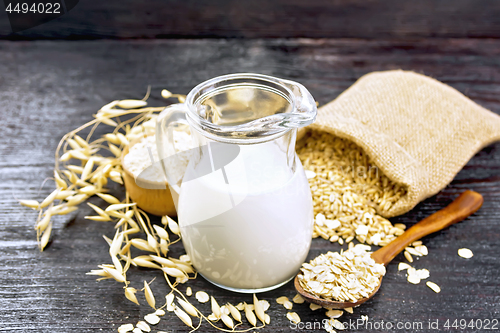 Image of Milk oatmeal in jug on dark board