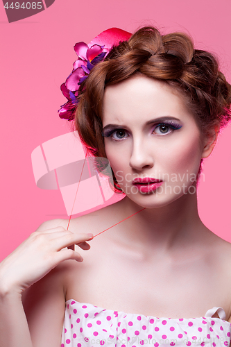 Image of Beautiful girl with bright make-up and pink hat