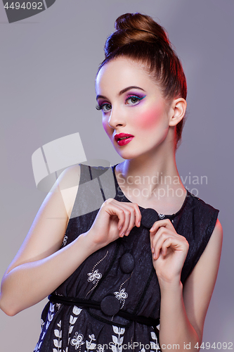 Image of Beautiful girl with hairdo and bright make-up