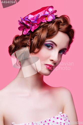 Image of Beautiful girl with bright make-up and pink hat