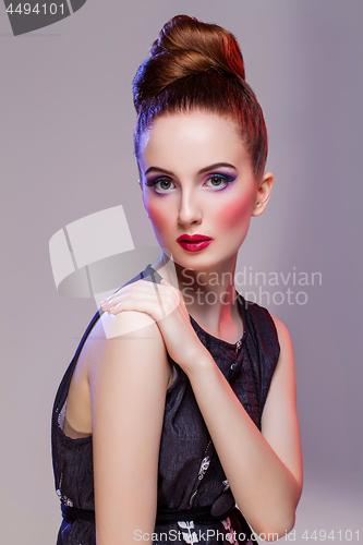 Image of Beautiful girl with hairdo and bright make-up