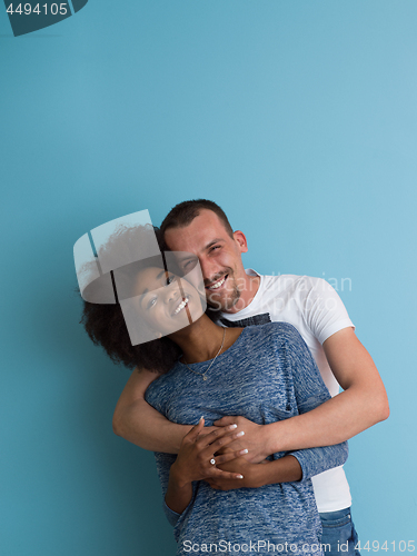 Image of multiethnic couple laughing and hugging