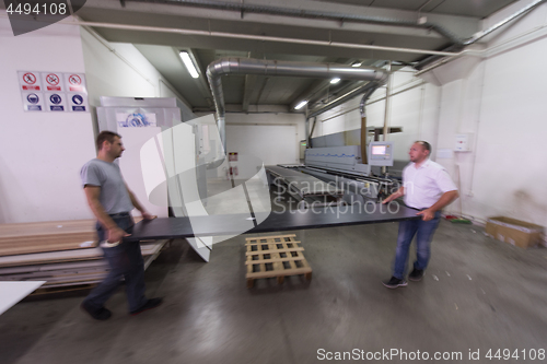 Image of workers in a factory of wooden furniture