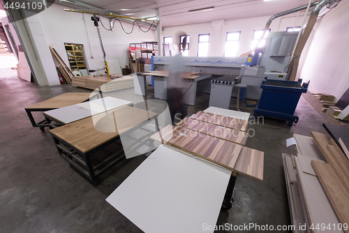 Image of worker in a factory of wooden furniture