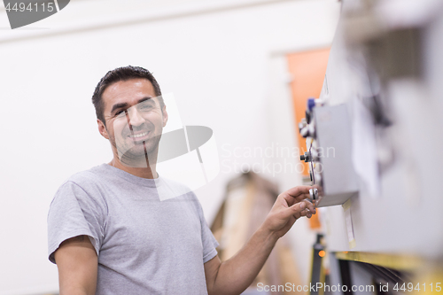 Image of worker in a factory of wooden furniture