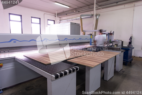 Image of worker in a factory of wooden furniture