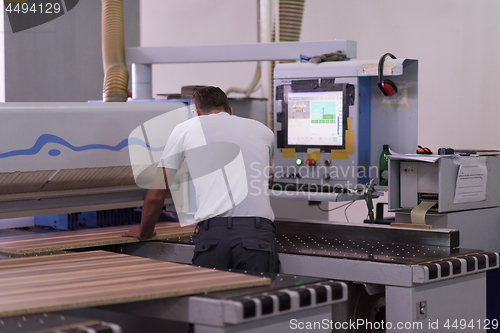 Image of worker in a factory of wooden furniture