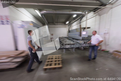 Image of workers in a factory of wooden furniture