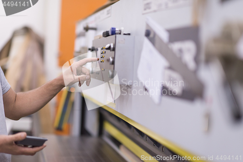 Image of worker in a factory of wooden furniture