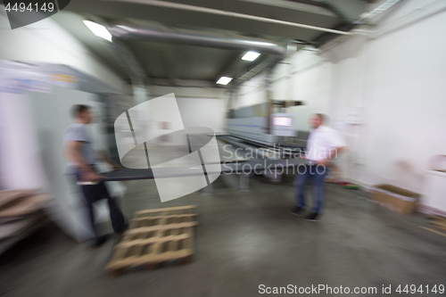 Image of workers in a factory of wooden furniture