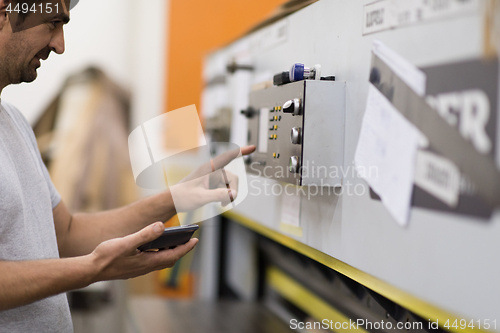 Image of worker in a factory of wooden furniture