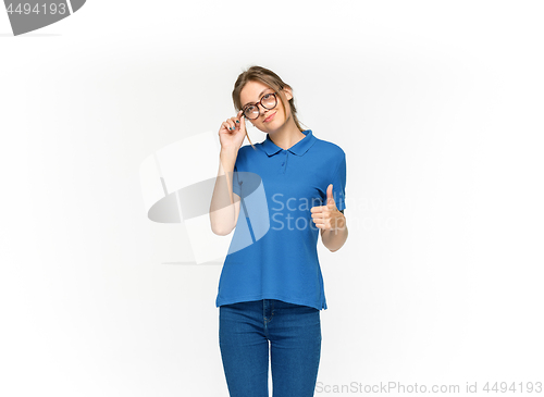 Image of Closeup of young woman\'s body in empty blue t-shirt isolated on white background. Mock up for disign concept