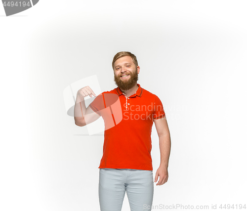 Image of Closeup of young man\'s body in empty red t-shirt isolated on white background. Mock up for disign concept