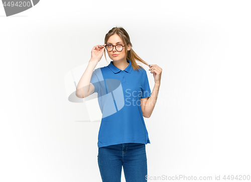 Image of Closeup of young woman\'s body in empty blue t-shirt isolated on white background. Mock up for disign concept