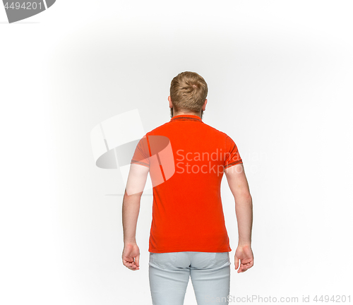 Image of Closeup of young man\'s body in empty red t-shirt isolated on white background. Mock up for disign concept