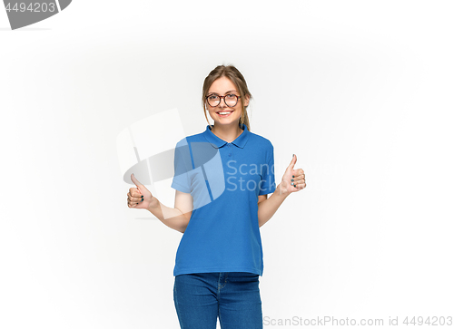 Image of Closeup of young woman\'s body in empty blue t-shirt isolated on white background. Mock up for disign concept