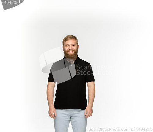 Image of Closeup of young man\'s body in empty black t-shirt isolated on white background. Mock up for disign concept