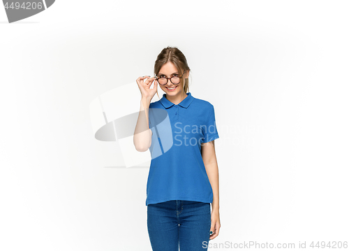 Image of Closeup of young woman\'s body in empty blue t-shirt isolated on white background. Mock up for disign concept