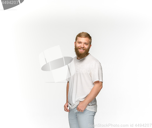 Image of Closeup of young man\'s body in empty white t-shirt isolated on white background. Mock up for disign concept