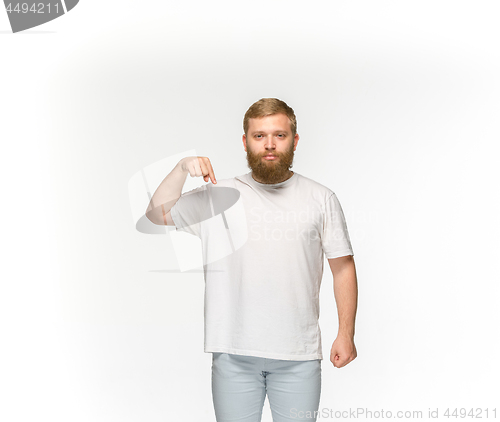 Image of Closeup of young man\'s body in empty white t-shirt isolated on white background. Mock up for disign concept