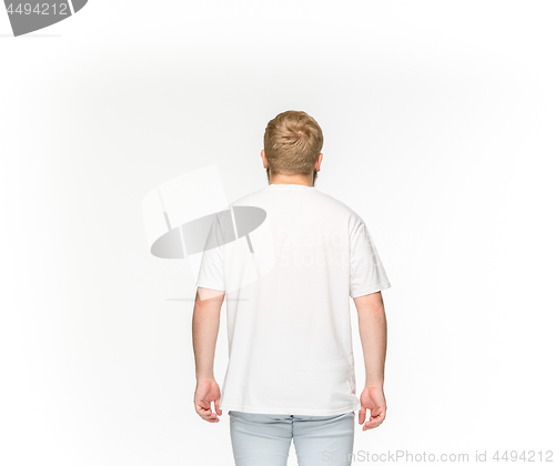 Image of Closeup of young man\'s body in empty white t-shirt isolated on white background. Mock up for disign concept