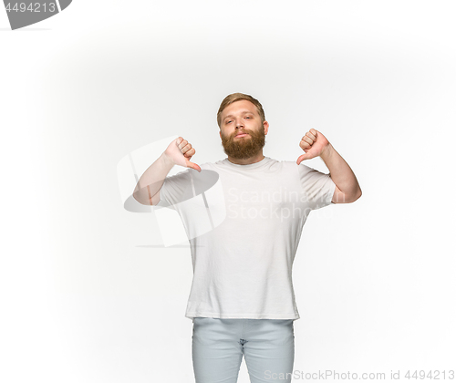 Image of Closeup of young man\'s body in empty white t-shirt isolated on white background. Mock up for disign concept