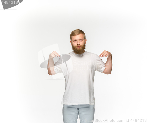 Image of Closeup of young man\'s body in empty white t-shirt isolated on white background. Mock up for disign concept