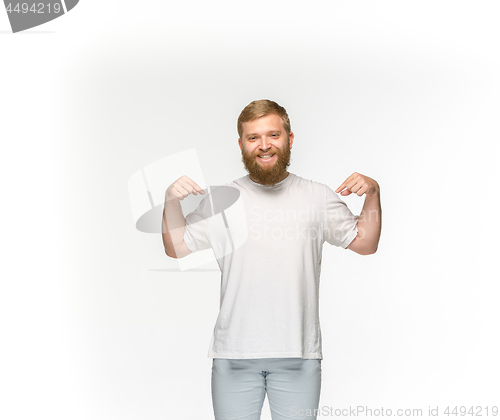 Image of Closeup of young man\'s body in empty white t-shirt isolated on white background. Mock up for disign concept