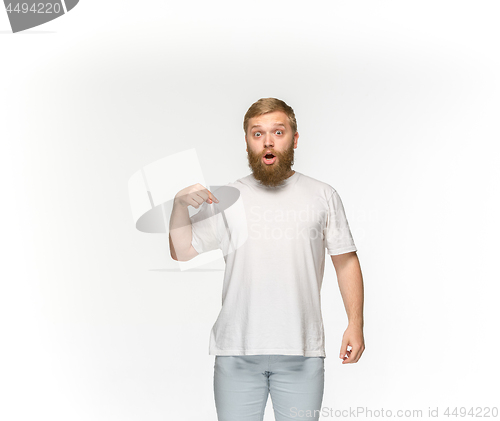 Image of Closeup of young man\'s body in empty white t-shirt isolated on white background. Mock up for disign concept
