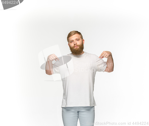 Image of Closeup of young man\'s body in empty white t-shirt isolated on white background. Mock up for disign concept