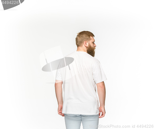 Image of Closeup of young man\'s body in empty white t-shirt isolated on white background. Mock up for disign concept