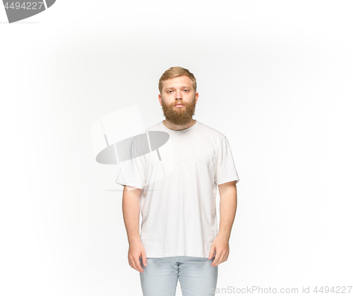 Image of Closeup of young man\'s body in empty white t-shirt isolated on white background. Mock up for disign concept