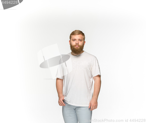 Image of Closeup of young man\'s body in empty white t-shirt isolated on white background. Mock up for disign concept