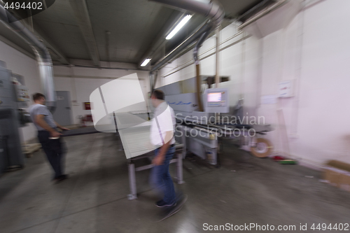 Image of workers in a factory of wooden furniture