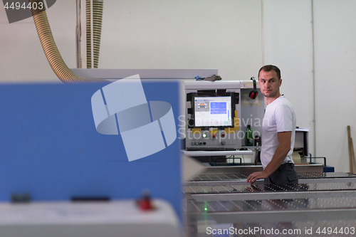 Image of worker in a factory of wooden furniture