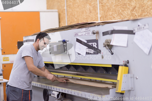 Image of worker in a factory of wooden furniture