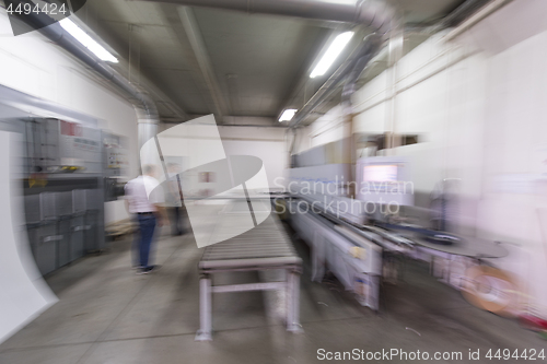 Image of workers in a factory of wooden furniture