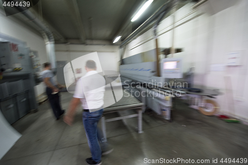 Image of workers in a factory of wooden furniture