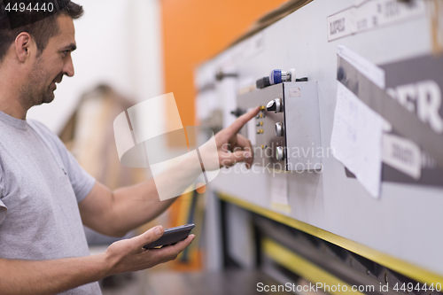 Image of worker in a factory of wooden furniture