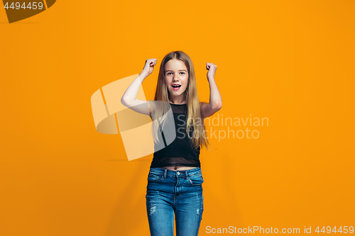 Image of Happy success teen girl celebrating being a winner. Dynamic energetic image of female model