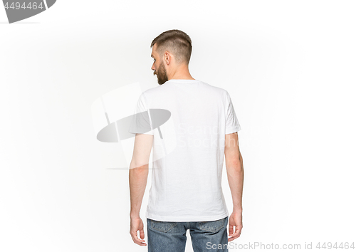 Image of Closeup of young man\'s body in empty white t-shirt isolated on white background. Mock up for disign concept